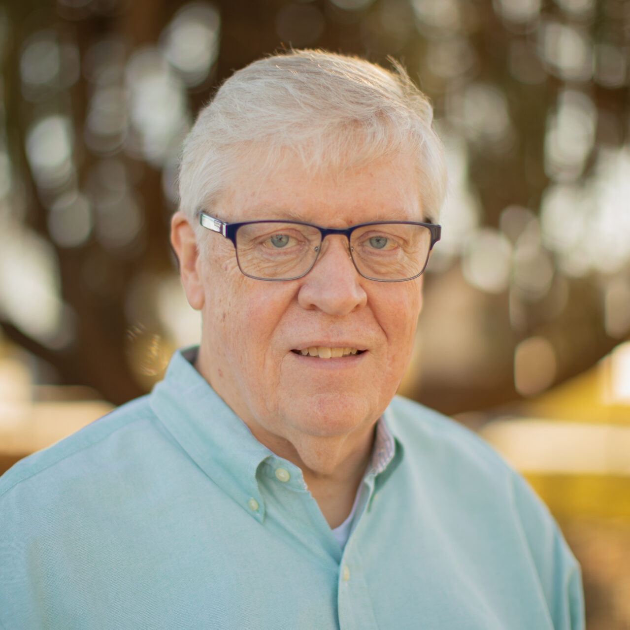 Bryan Ahlers standing outside with a blurred background.